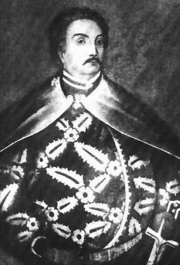 Schwarzes und weißes Foto von Papst Johannes Paul II. in Priesterkleidung, der eine schwarze Robe mit weißem Kragen und Manschetten trägt und seine Hände falt, mit einem strengen Gesichtsausdruck und direktem Blick.