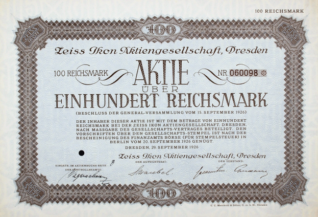 Deutsches Aktienzertifikat über einhundert Reichsmark mit schwarzem Rand und gedrucktem Text.