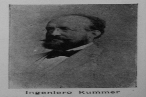 Ein Schwarz-Weiß-Foto eines bärtigen Mannes in einem Blazer und einer Brille, mit dem Text "Ingenlero Kummer, der Gründer der deutschen Revolution" unten.